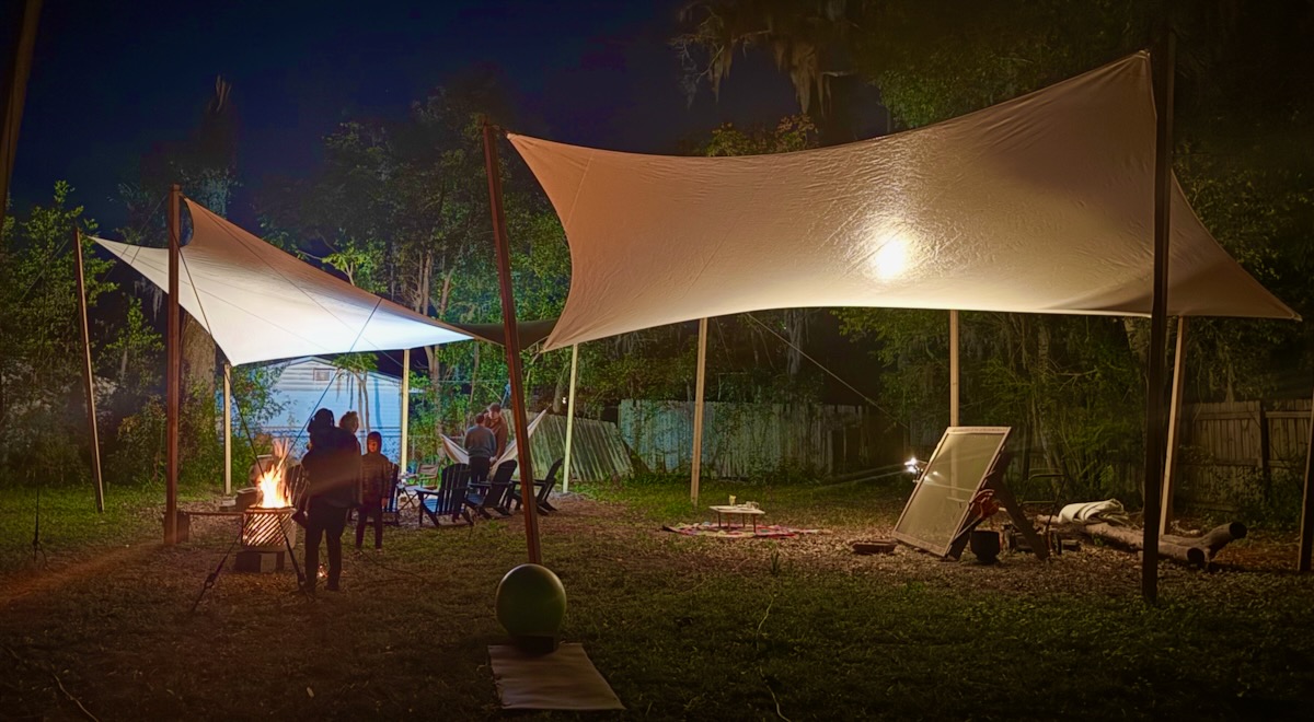 double shade cloth RainShade by windfire designs at night showing lights diffusing over a party