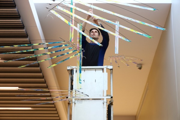 Tim Elverston installing the HandFlow kinetic mobile, blues colorway