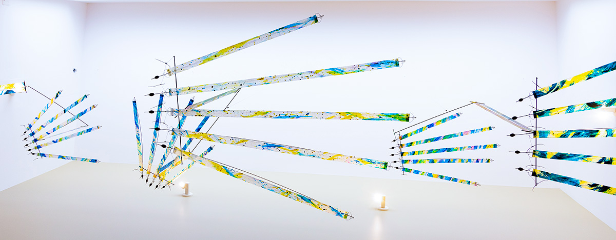 Painted hand mobiles photographed from below — WindFire Designs kinetic installation