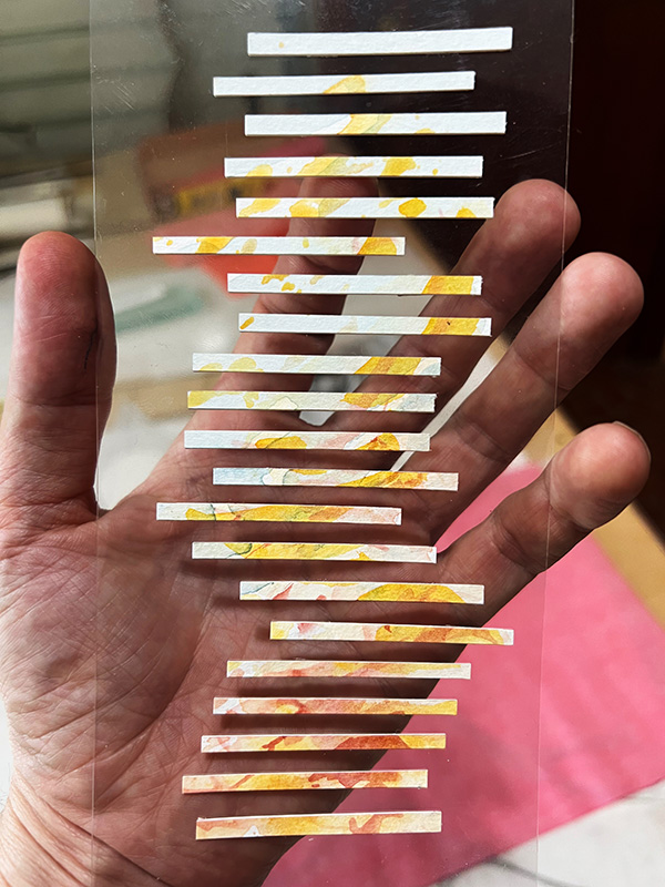small model of painted strips of aircolor stacks kinetic art maquette