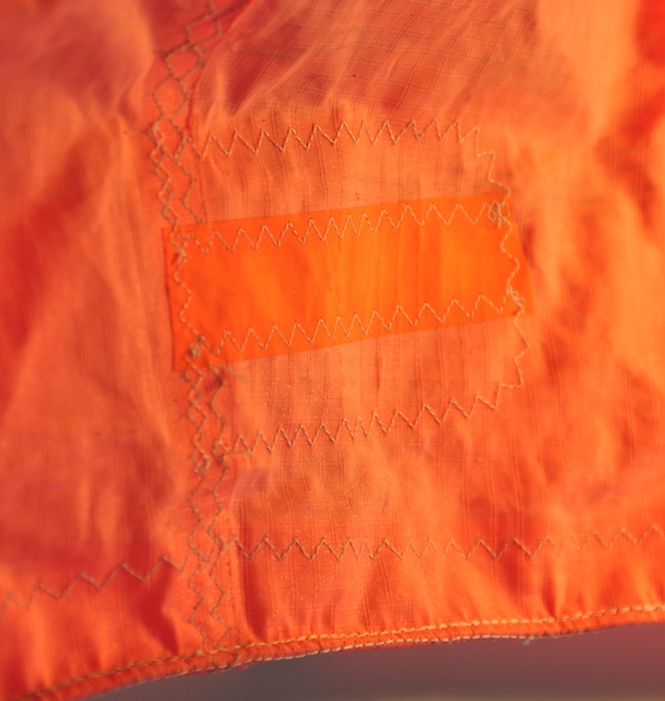 Cabrinha leading edge gash showing curved fiber displacement around the damage
