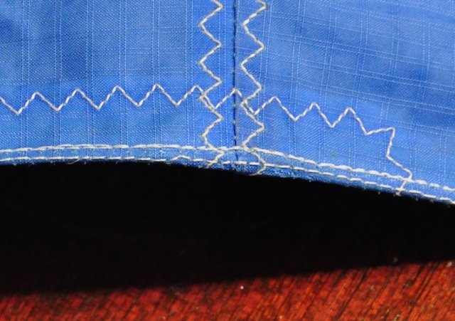 Repaired Cabrinha leading edge closure seam showing factory stitching and WindFire repair stitching